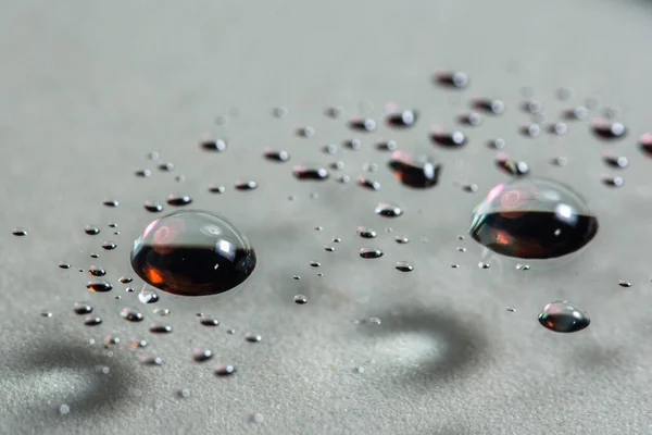 Macro background dripping water on clear glass