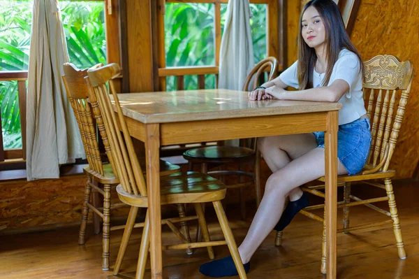 beautiful woman sitting on a chair in a cafe