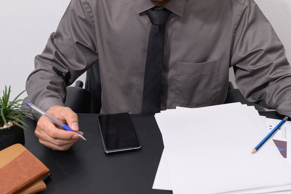 Business people check documents at their desks
