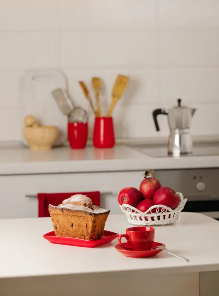 Interior white kitchen with kitchen tools and red crockery. Selective focus.