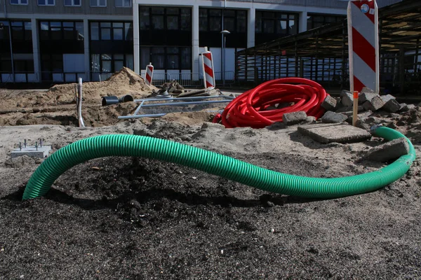 pipes an other materials laying on the ground at a unfinished construction site