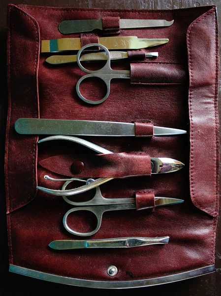 Close up of a foldable leather, dark red manicure set — Stock Photo, Image