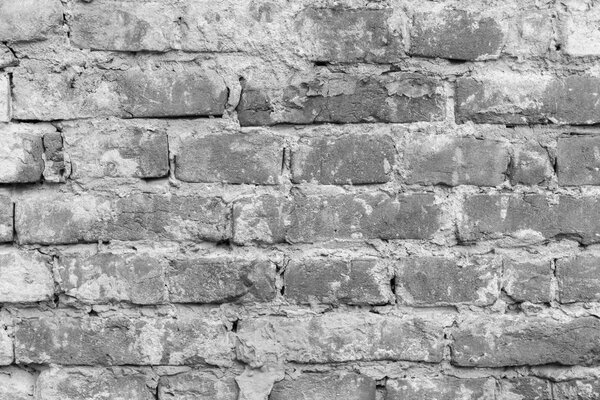 Old grunge uneven brick wall textured background