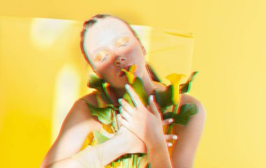Young beautiful woman with the face of freckles wearing in yellow dress near background with afternoon shadows. Anaglyph 3d effect.