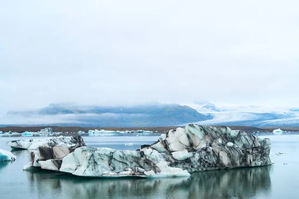 Светящиеся Голубые Айсберги Плавающие Ледниковой Лагуне Джоколсарлон Фоне Ледниковой Горы — стоковое фото