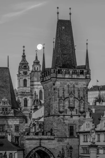 The full moon is the lunar phase when the Moon appears fully illuminated from Earth's perspective. Prague, the capital and largest city of the Czech Republic. Mysterious streets, historic district, magic part, tourist destination. One of the major to