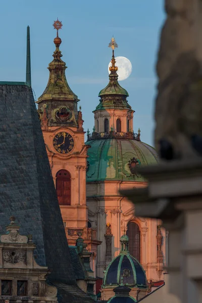 The full moon is the lunar phase when the Moon appears fully illuminated from Earth's perspective. Prague, the capital and largest city of the Czech Republic. Mysterious streets, historic district, magic part, tourist destination. One of the major to