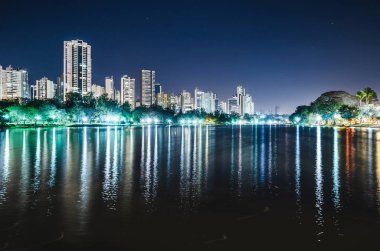 Photo of the Lago Igapo, Londrina - Parana, Brazil. View of the Igapo lake at night and the city, buildings on background. Leisure place, touristic destination of the city. clipart