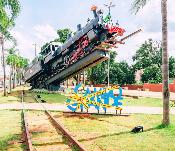 Campo Grande, Brazil - October 29, 2018: Monument of a big black train inclined up to the sky. Memorial Ferroviario (Maria fumaca) at Orla Ferroviaria (Avenida Calogeras). Historic mark of the city.