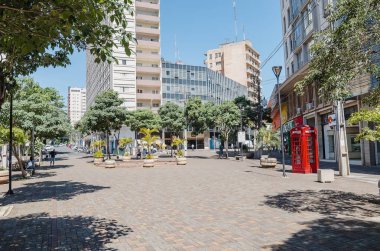 Londrina - PR, Brazil - December 12, 2018: Parana avenue, the main downtown street with shops, commerce, local people and historic buildings. Known by local people as Calcadao (Calcadao de Londrina). clipart
