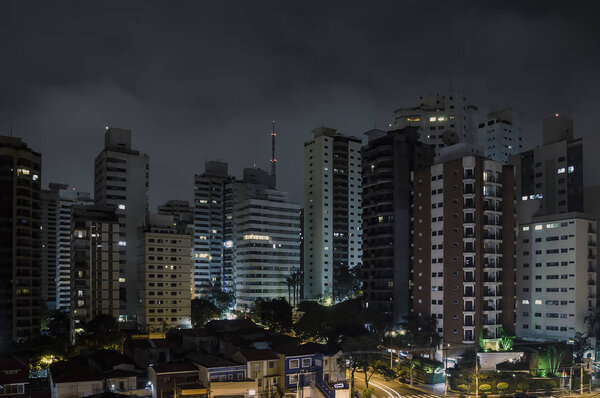 Buildings of Sao Paulo city at a cloudy night. Urban photo of the city during night.