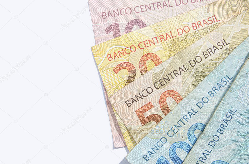 Brazilian real banknotes background isolated on white.