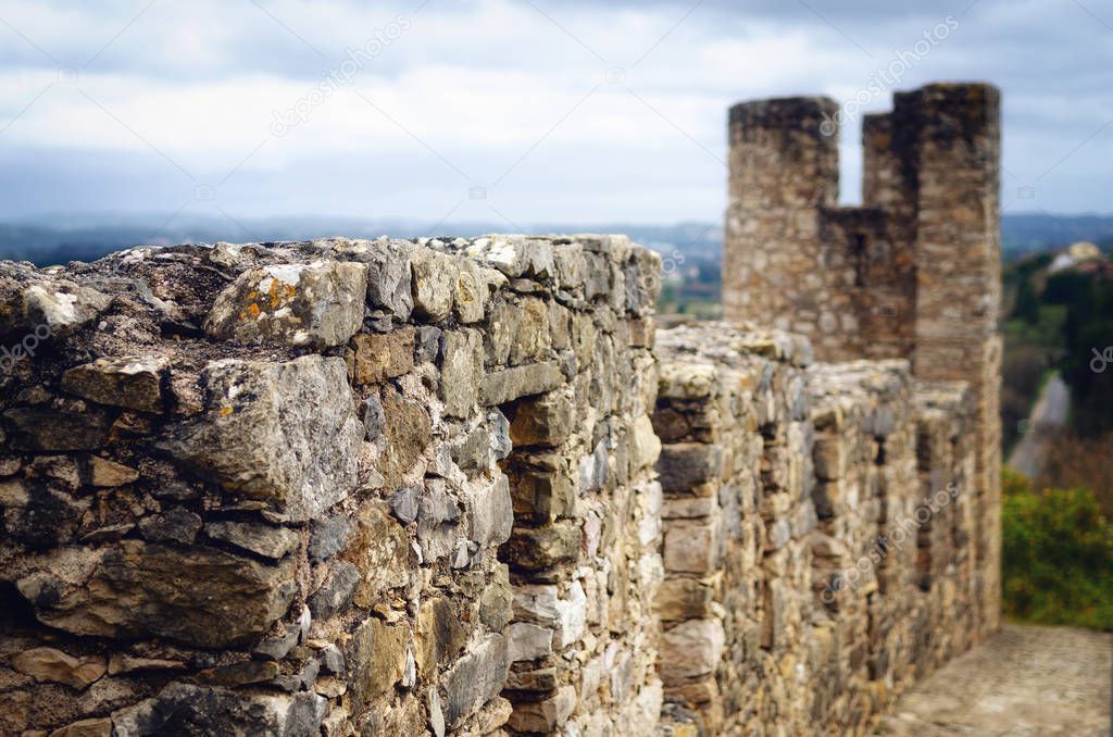 Ancient stone castle walls of the Convent of Christ, stronghold of the templar knights in Tomar, Portugal, near Lisbon