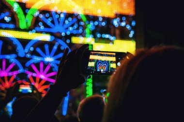 Cuneo Illuminata sırasında bir kadın el tarafından düzenlenen bir akıllı telefon ile kaydedilen ışık ve müzik performansı