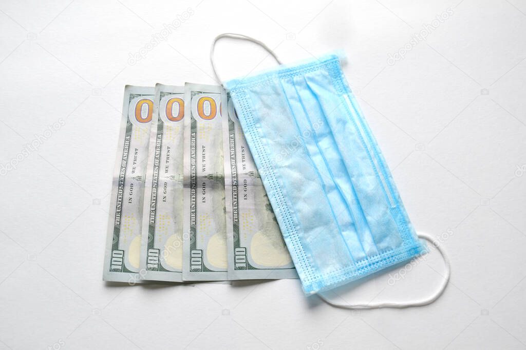 Surgical face masks and USA Dollar Banknotes, inflated export and import, mandatory masking, covid-19 and coronavirus
