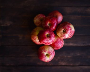 ahşap bir masa üzerinde olgunlaşmış çizgili elma