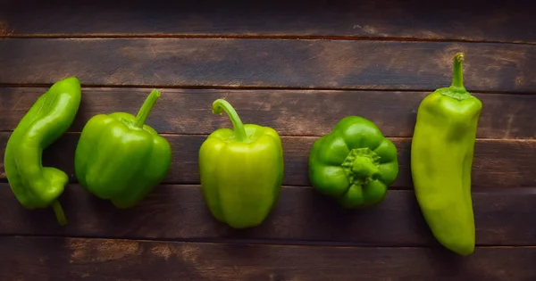 green bell pepper on wooden table
