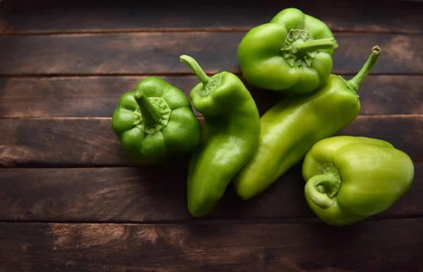 green bell pepper on wooden table