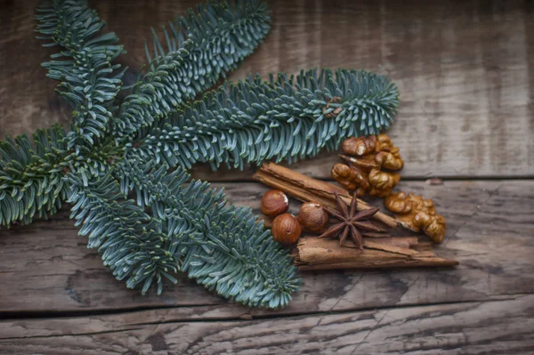 green fir branches on the background of boards