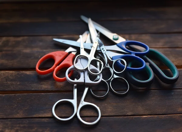 scissors of different size and purpose on a wooden table