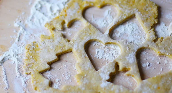 the dough for the shortbread in a heart shape on cutting Board