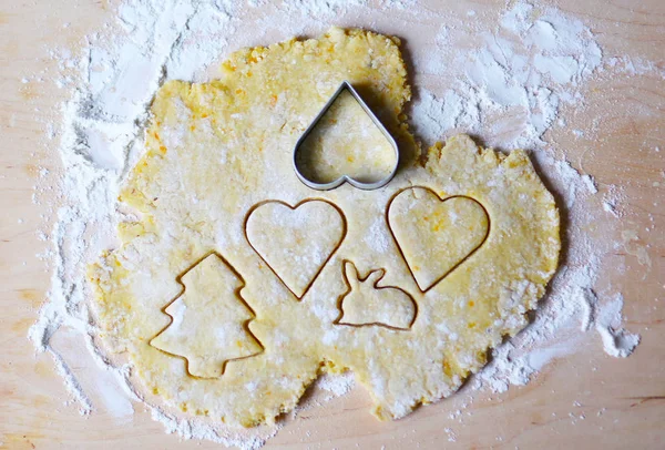 the dough for the shortbread in a heart shape on cutting Board