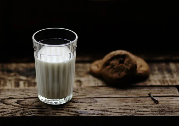 Tahta Arka Planda Çikolata Parçacıkları Olan Bir Bardak Süt Kurabiyesi — Stok fotoğraf