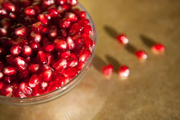Pomegranate on gold background, healthy food