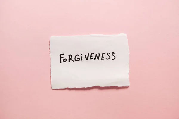 Forgiveness Text White Real Paper Pink Background — Stock Photo, Image