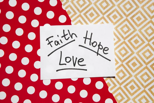 Faith, hope and love - words on red and golden background, christianity and religion concept