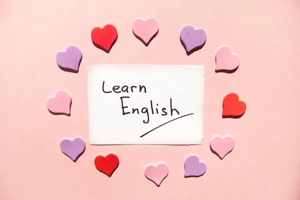Learn English - text on white paper on pink background with heatrs, studying language