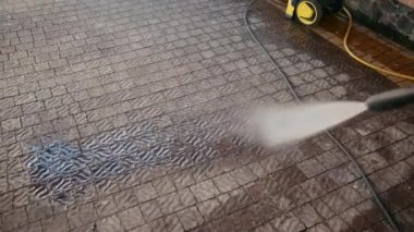 erkek, temizleyici, yüksek basınçlı su bir jet ile parke taşları yıkar, yakın çekim
