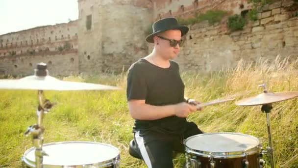 Muzikant drummer gekleed in zwarte hoed, spelen Drum Set en bekkens, op straat — Stockvideo