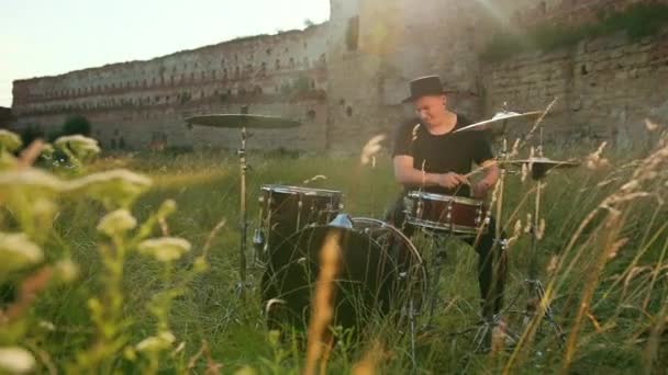 Muzikant drummer gekleed in zwarte kleren, hoed, het spelen van de drum set en bekkens — Stockvideo