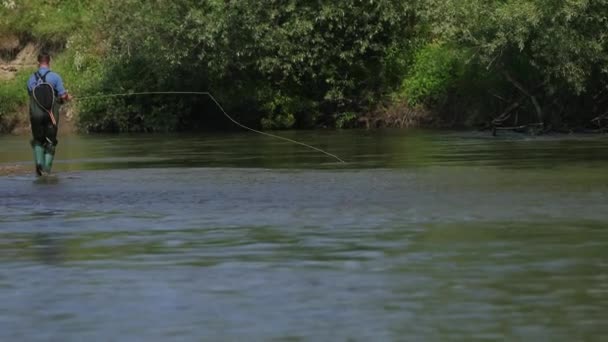 낚싯대를 들고 있는 어부, 수레를 던지고 강에서 낚시 — 비디오