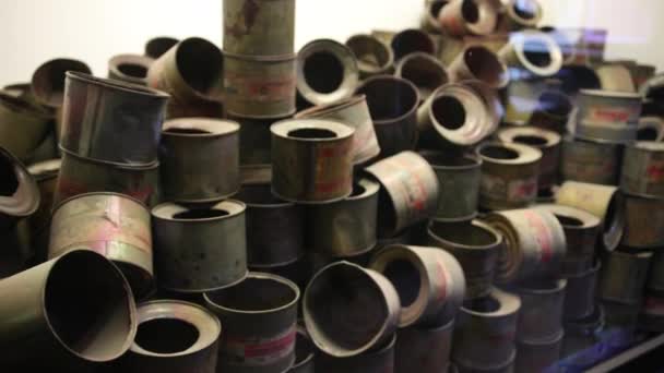 Veel oude, gebruikte open metalen blikjes, die giftig gas was, met geplakte etiketten — Stockvideo