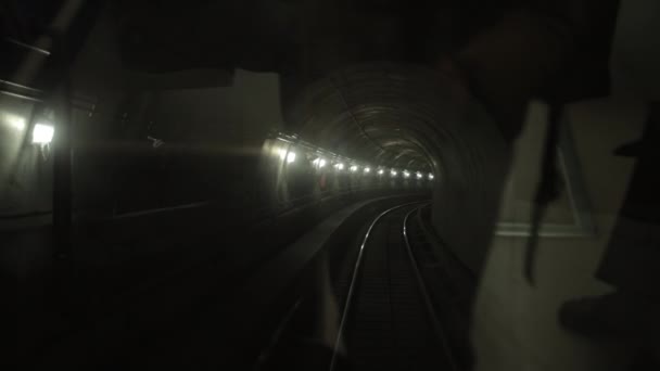 Dark underground train tunnel, deep down, subway car rides on rails in subway — Stock Video