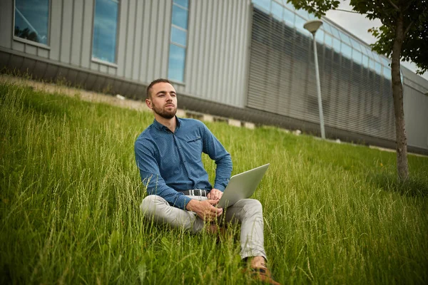 Manager holding laptop, Out of office work, young businessman using computer