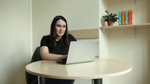 Female employee talk on video call with coworkers engaged online briefing home — Stock Video