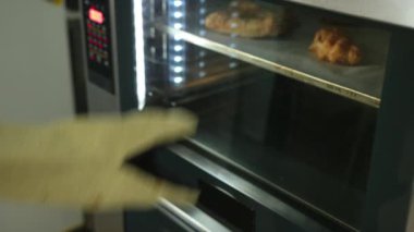 Fırından fırında pişmiş turta çıkaran kişi. Fırında erkek fırıncı, adam turta pişiriyor.