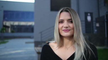 Yarı hoşsohbet biriyle konuşan güzel bir iş kadınının portresi.