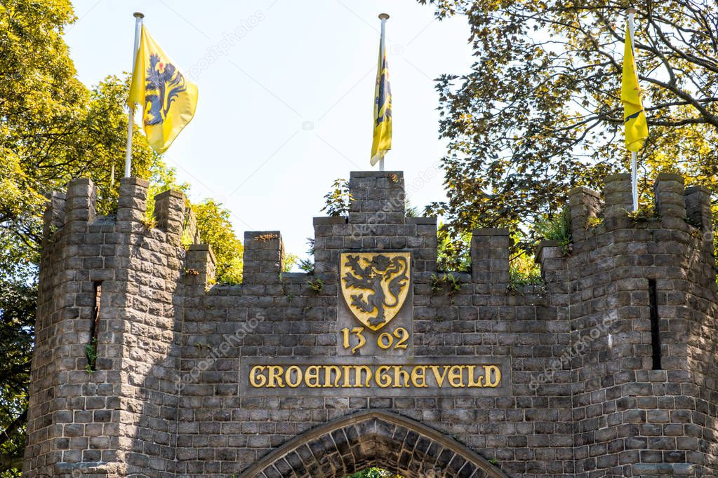 Flemish Lion flags on top of the Groeningegate, a triumphal arch (1906) at the former Groeningefield where the Battle of the Golden Spurs (Guldensporenslag) was fought July 11 1302. Kortrijk, Flanders, Belgium