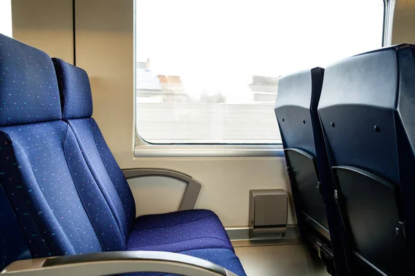 Two empty blue train seats, public travel concept