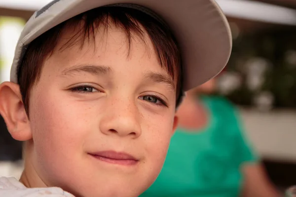 Little boy with gray baseball hat