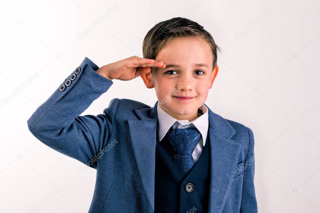 Young boy dressed up saluting