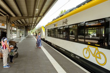 Titisee-Neustadt, Baden-Wurttemberg, Almanya - 28 Temmuz 2020: Titisee tren istasyonundaki Bwegt (DB regio) yolcu treni, platformda maskeli yolcular