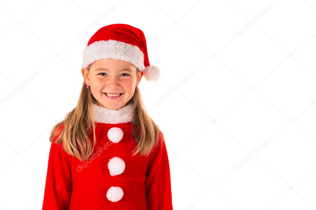 Portrait of beautiful 8 year old girl smiling and wearing red christmas costume with red dress and a Santa Claus hat isolated on white