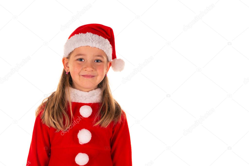 Portrait of beautiful cheerful 8 year old girl smiling and wearing red christmas costume with red dress and a Santa Claus hat isolated on white