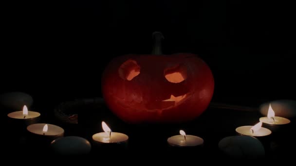 Jacks pumpkin lantern surrounded by candles and snakes - Halloween decoration — Stock Video