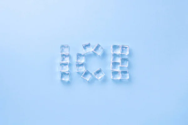 Word Ice Lined Ice Cubes Light Blue Background Flat Lay — Stock Photo, Image